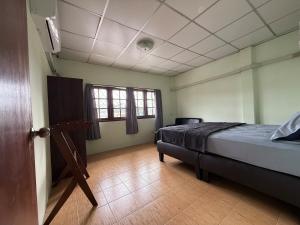 a bedroom with a bed and a television in it at Penny Hostel & Cafe in Thong Sala