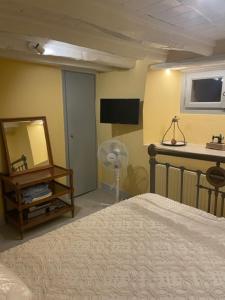 a bedroom with a bed and a mirror at 1867 Manor in Leonidio