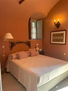 a bedroom with a large bed with pink pillows at 1867 Manor in Leonidio