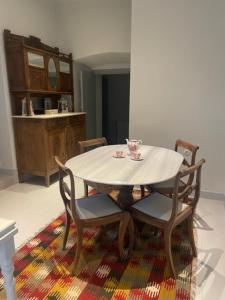 a table with two chairs and a white table with a cup at 1867 Manor in Leonidio