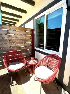 three red chairs and a table on a patio at Charismatic Downtown Solvang Pet-Friendly Studio in Solvang
