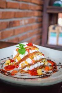 a plate with a dish of food on a table at Blue Breeze - Jetwing Select in Negombo
