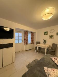 a living room with a television and a table at Kochet Pitters Home in Sibiu