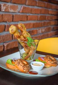 a plate of food with shrimp and sandwiches on a table at Blue Breeze - Jetwing Select in Negombo +17 photos