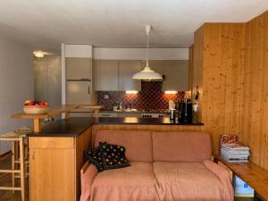 a living room with a couch in a kitchen at Bel Air C27 in Champéry
