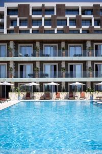 a swimming pool in front of a hotel at Hotel Vlora Priam, Affiliated by Melia in Vlorë