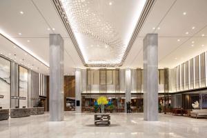a lobby of a building with columns and a building at Wyndham Shanghai Pudong in Shanghai