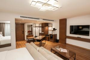 a living room with a couch and a bed at Riva Hotel Nişantaşı in Istanbul