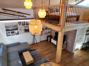 an overhead view of a living room with a loft at la maisonnette in Saignelégier