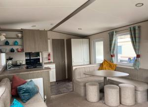 a living room with a couch and a table at Vern's Van in Pendine
