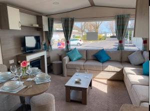 a living room with a couch and a table at Vern's Van in Pendine