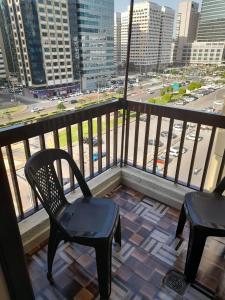 balcone con 2 sedie e vista sulla città di Yasliving EXTN a Abu Dhabi