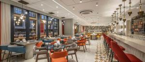 a restaurant with tables and chairs and a bar at Doubletree By Hilton Suites Trabzon Yomra in Trabzon