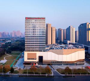 a large building in a city with tall buildings at Hilton Garden Inn Hefei High-Tech Zone in Hefei