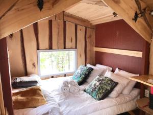a bedroom with a white bed with pillows on it at Tahlo Luxury Tent Glamping in Mutala