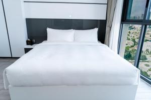Postel nebo postele na pokoji v ubytování Noden Hotel & Apartment
