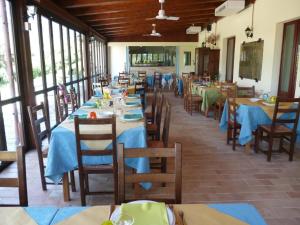 a dining room with tables and chairs with blue table cloth at Agriturismo Vivace in Tolentino