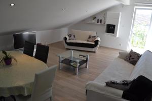 a living room with a couch and a table at Apartment Branko in Vodice