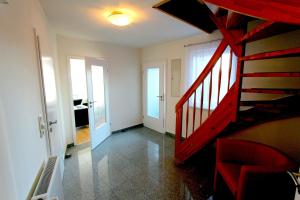 a living room with a spiral staircase in a house at FERIENHAUS SEENSUCHT in Malchow