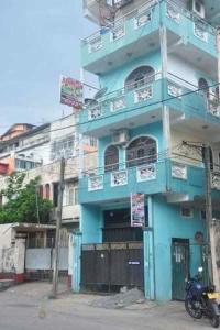 a blue building with a motorcycle parked in front of it at Manimalar guest in Colombo