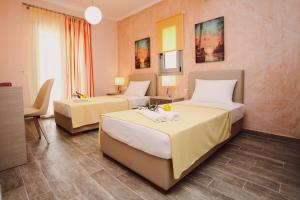 Postel nebo postele na pokoji v ubytování Ionian Diamond Villas + 35 fotografií