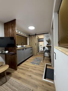 a kitchen with wooden floors and a counter top at KrpaHaus in Horná Lehota
