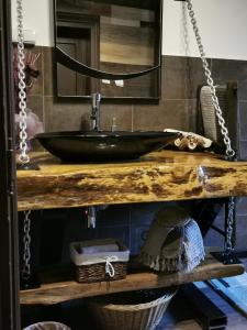 a bathroom with a black sink on a wooden table at Complex Chalet -Turlashkata Kushta in Gabrovo