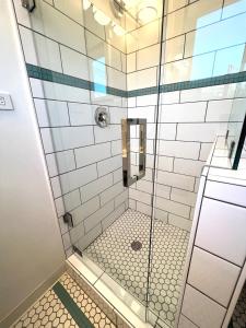 a bathroom with a shower with a glass door at Urban Luxe Retreat l King Bed l Kitchenette in Solvang +35 photos