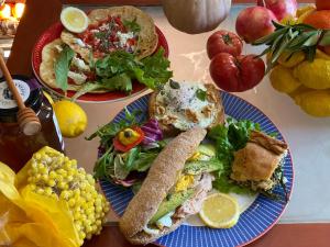 a table with two plates of food and a salad at Stratos ArtDeco House in Kalavasos