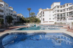 a large swimming pool in front of some buildings at Benalmar Playa in Benalmádena