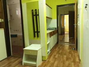 a kitchen with green walls and wooden floors at Anna Vendégház in Hévíz +49 photos