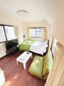 Postel nebo postele na pokoji v ubytování Ueno Sky Garden