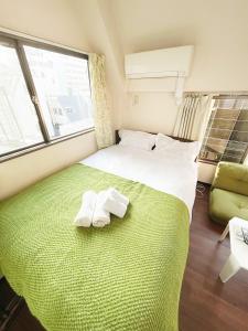 Postel nebo postele na pokoji v ubytování Ueno Sky Garden