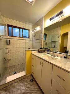 a bathroom with a shower and a sink and a mirror at Downtown Solvang l Most Desired Home l 2BR in Solvang +44 photos
