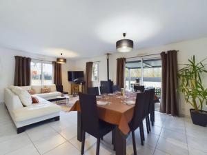 a dining room with a table and chairs at Maison avec jardin et jacuzzi pour 8 personnes in Saint-Hilaire-de-Riez