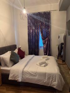 a bedroom with a large bed with a window at Maison du Lac in Kastoria
