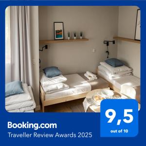 a room with two beds and a table in it at Apart Hostel S8 in Blizne Jasińskiego