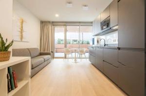 a kitchen and living room with a couch and a table at Genoa Downtown East Water Front in Genova