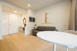 a living room with a white table and a couch at Genoa Downtown East Water Front in Genova