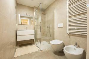 a bathroom with a shower and a toilet and a sink at Genoa Downtown East Water Front in Genova +36 photos