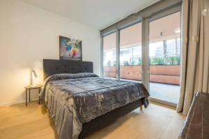 a bedroom with a bed and a large window at Genoa Downtown East Water Front in Genova