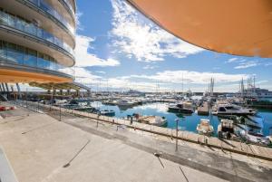 a marina with boats in the water next to a building at Genoa Downtown East Water Front in Genova
