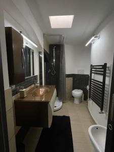 a bathroom with a sink and a toilet at Artemide Resort Spa - Private Villa & Spa Suites in Lido Di Fondi +51 photos