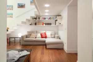 a white living room with a couch and stairs at Riccardo Luxury Apartment in Bari