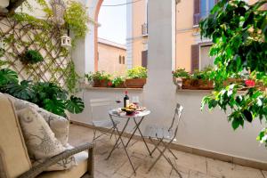 a small table with a bottle of wine on a balcony at Riccardo Luxury Apartment in Bari