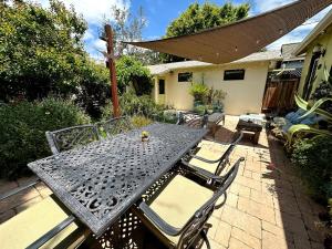 a metal table and chairs on a patio at Couples Cottage l Steps to Downtown in Solvang