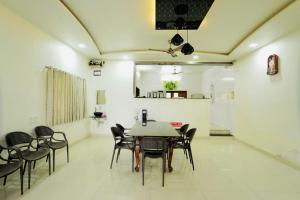 Mahalaxmi Hills في ماهاباليشوار: غرفة طعام مع طاولة وكراسي