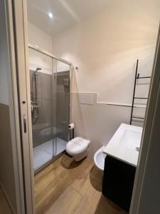 a bathroom with a shower and a toilet and a sink at Handy in Brindisi