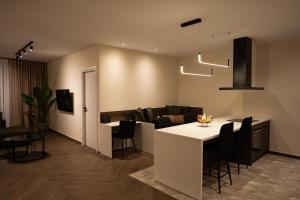 a kitchen and living room with a table and chairs at Kalma Luxury Living Athens in Athens