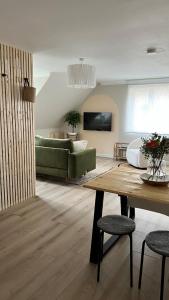 a living room with a green couch and a table at Luxury coastal retreat - On-site parking - sleeps 4 in Ilfracombe